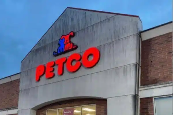 Before: Storefront of a Petco with a red sign displaying the company name, under a cloudy evening sky.