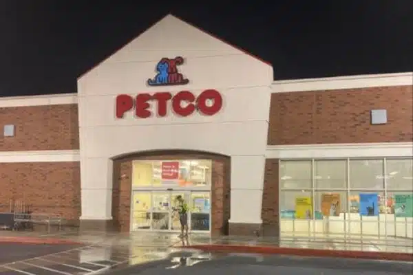 After: Exterior of a Petco store at night, featuring a large sign and a person with a dog outside.